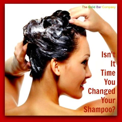 A woman using a shampoo bar on her hair