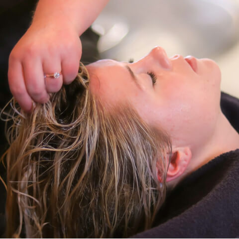 Woman having hair washed