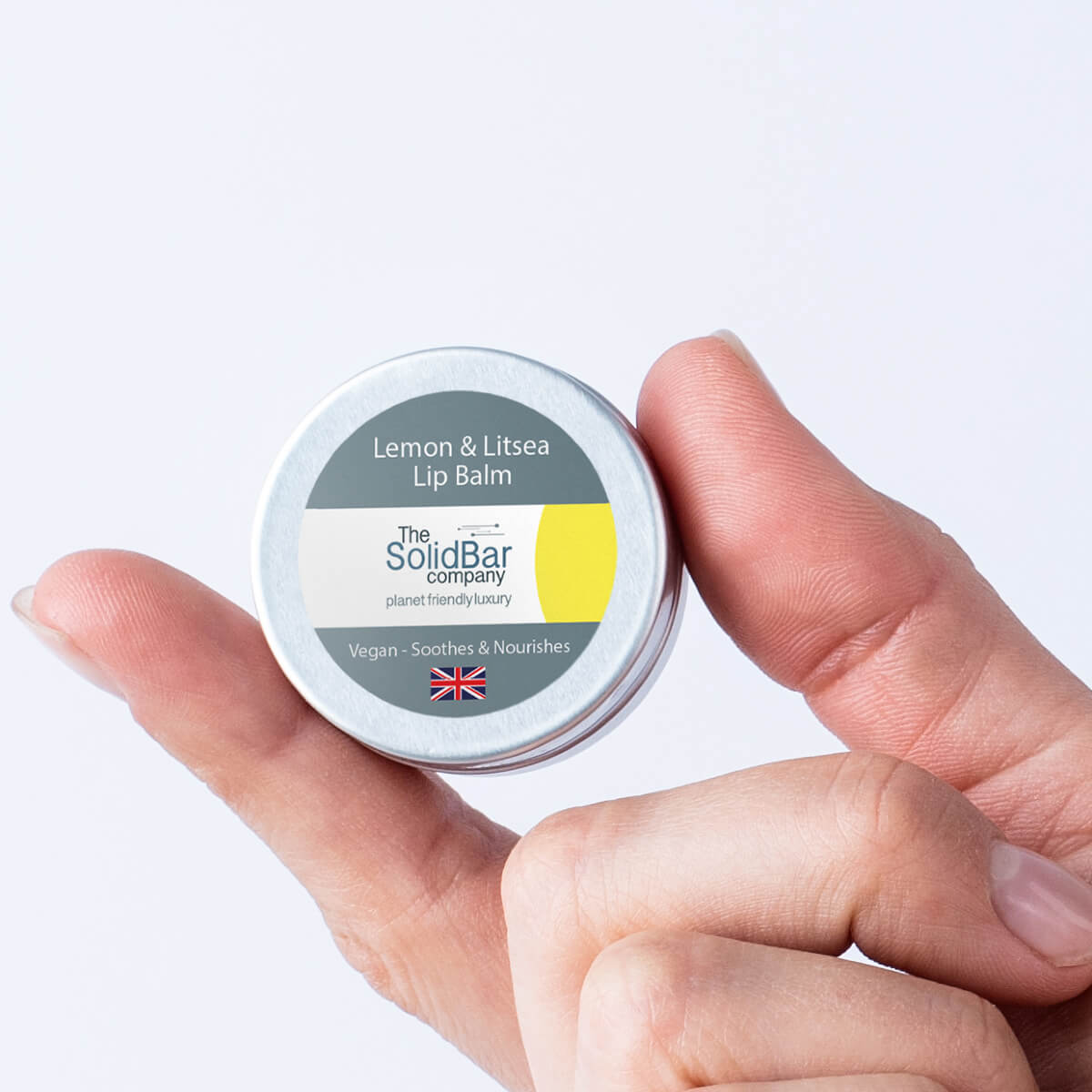 Lemon Litsea Lip Balm being held in fingers